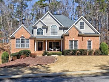 Charming brick home featuring a well-manicured front yard and inviting curb appeal at 112 Estates At The Lake Dr, Canton, GA 30114