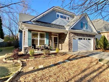 Charming two-story home with stone accents, attached garage, manicured lawn and covered front porch at 107 Deer Park Dr, Carrollton, GA 30116