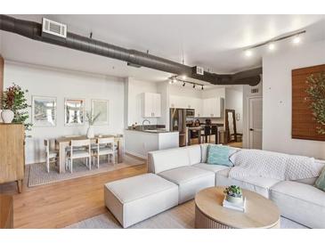 Open-concept living room boasts modern design with an eat-in kitchen and dining area, perfect for entertaining at 5300 Peachtree Rd # 0507, Atlanta, GA 30341