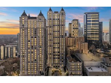 Stunning high-rise condo building with beautiful architecture against a vibrant sunset sky at 195 14Th Ne St # 2105, Atlanta, GA 30309