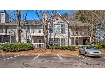 Inviting townhome featuring a neutral exterior, balcony, mature landscaping and parking at 308 Gettysburg Pl, Atlanta, GA 30350