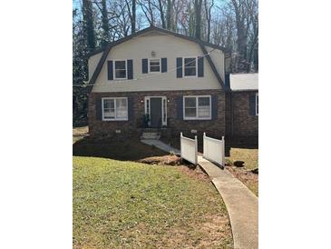 Charming two-story home with brick and siding, a cozy front yard, and inviting curb appeal at 4809 Thompson Mill Rd, Lithonia, GA 30058