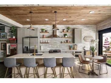 Modern kitchen boasts stainless steel appliances, a spacious island, and stylish wood ceiling at 890 Memorial Se Dr # 101, Atlanta, GA 30316