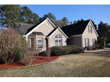 Charming brick home with well-maintained landscaping and mature trees in a quiet neighborhood at 1313 Idlewood Ct, Mcdonough, GA 30252