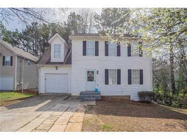 Charming two-story home featuring white siding, black shutters, and an attached garage at 2149 Shoals Way, Decatur, GA 30034