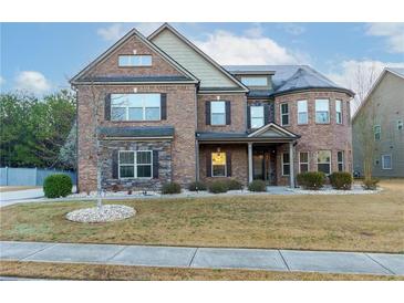 Stunning two-story brick home featuring stone accents and a well-manicured front lawn at 3070 Staglin Dr, Powder Springs, GA 30127