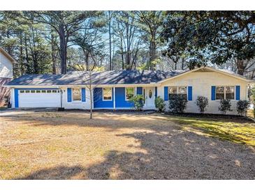 Charming one-story brick home with blue trim, attached garage, and a well-maintained front yard at 2519 Lauderdale Ne Dr, Atlanta, GA 30345