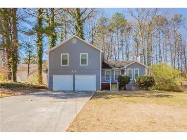 Charming home with a two-car garage and a well-maintained front yard at 6265 Stoney Cv, Austell, GA 30168