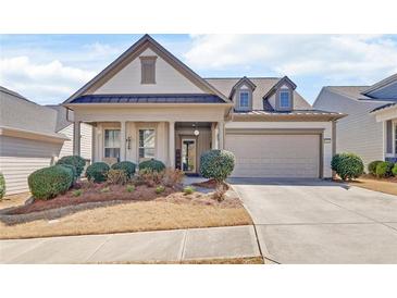 Charming single-Gathering home boasts a manicured front yard, inviting entrance, and attached two-car garage at 5719 Sierra Bend Way, Hoschton, GA 30548