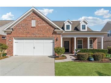 Charming brick home featuring a well-maintained front yard and a two-car garage at 2975 Thistle Trl, Suwanee, GA 30024