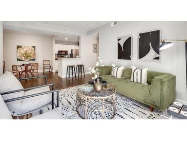 Inviting living room features modern decor, stylish furniture, and an open floor plan leading to the kitchen at 1074 Peachtree Ne Walk # B306, Atlanta, GA 30309