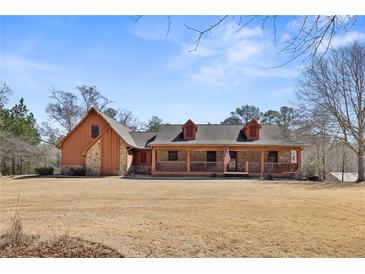 Charming single-Gathering home featuring a spacious front yard and a welcoming covered porch at 2999 Paul Harris Rd, Dallas, GA 30157