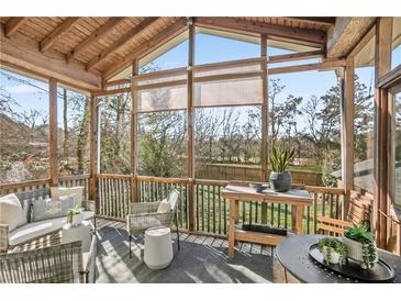 Relaxing screened-in porch with comfortable seating, stylish decor, and views of the outdoor landscape at 1848 Flagler Ne Ave, Atlanta, GA 30309