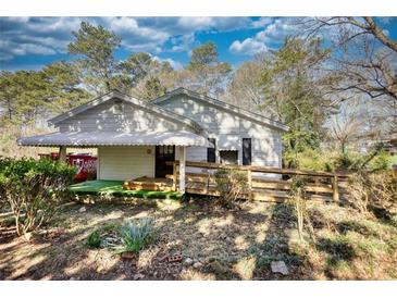 Charming home featuring a ramp to the front door, and lush greenery around the property at 5500 Rockbridge Road, Stone Mountain, GA 30088