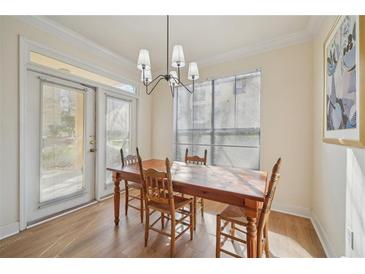 Bright dining area features a wooden table, chairs, and a modern chandelier, perfect for Gathering meals at 3777 Peachtree Ne Rd # 1007, Atlanta, GA 30319