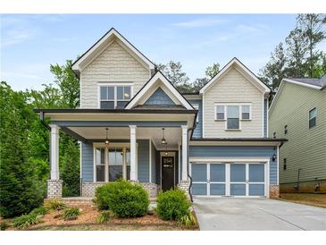 Charming craftsman-style home featuring a welcoming front porch, blue siding, and well-manicured landscaping at 628 Avondale Hills Dr, Decatur, GA 30032