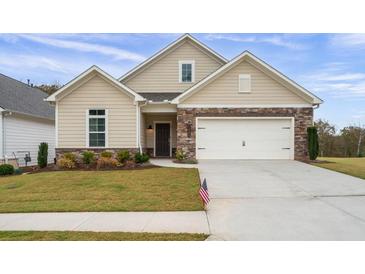 Beautiful home featuring stone accents, a well-manicured lawn, and a two-car garage at 4902 Pleasantry Way, Acworth, GA 30101