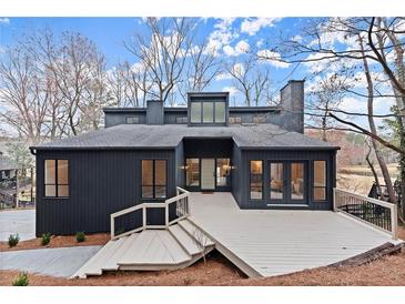 Modern two-story home with a unique architectural design and stylish gray exterior at 8700 Mount Rushmore Dr, Alpharetta, GA 30022