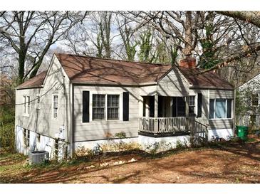 Charming single-Gathering home featuring a quaint front porch and a well-maintained lawn surrounded by mature trees at 2642 Joyce Ave, Decatur, GA 30032