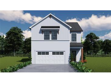 Charming two-story home with white siding, black trim, and a two-car garage at 4594 Eastbrook Pl, Snellville, GA 30039