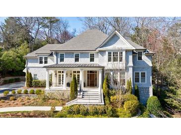 Stately two-story home with beautiful landscaping, symmetrical design and covered entryway with white pillars at 479 Argonne Nw Dr, Atlanta, GA 30305