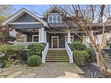 Charming two-story home with landscaped front yard, stone path and elegant porch at 289 9Th Ne St, Atlanta, GA 30309