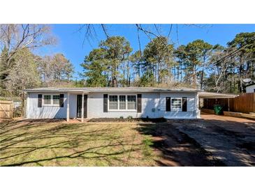 Charming single-story home featuring a brick facade, well-manicured lawn, and a convenient carport at 4214 Canby Ln, Decatur, GA 30035