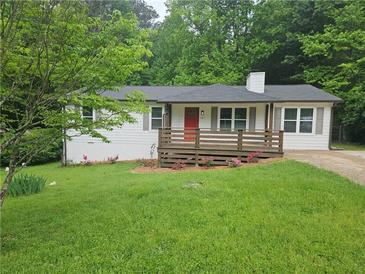 Charming home featuring a quaint front deck, white siding and a bright red door at 147 Mildred Ct, Dallas, GA 30157