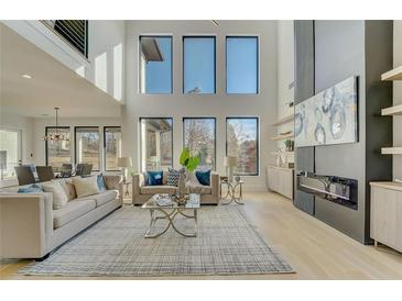 Bright, open living room with large windows, modern fireplace, and stylish furnishings at 2551 Kilgore Rd, Buford, GA 30519