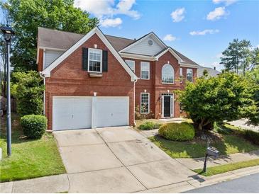 Beautiful brick home featuring a two-car garage and well-manicured front yard at 4831 Edinburgh Dr, Smyrna, GA 30082