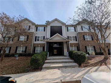 Three story building with brick and vinyl siding and black shutters at 5104 Fairington Village Dr # 5104, Lithonia, GA 30038