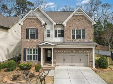 Charming brick home with a two-car garage, landscaped front yard, and elegant architectural details at 4325 Bellview Ln, Duluth, GA 30097