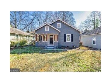 Charming one-story home featuring a welcoming front porch and well-maintained front yard at 2506 Maple St, East Point, GA 30344