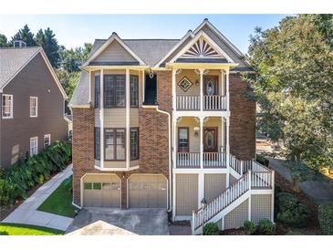 Charming brick home with a two-car garage and inviting double-decker front porches at 2533 Briers North Dr, Atlanta, GA 30360