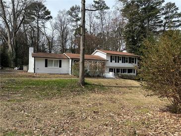 Charming two-story home with a brick exterior, trimmed black shutters and a well-maintained front yard at 6470 Wright Cir, Atlanta, GA 30328