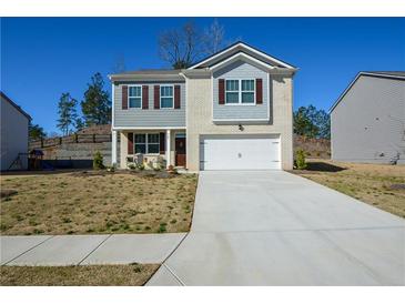 Charming two-story home featuring a two-car garage and a well-manicured front yard at 67 Highgrove Way, Dallas, GA 30157