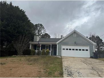 Charming single-Gathering home with a well-maintained front lawn and an attached two-car garage at 1007 Billy Mcgee Rd, Lawrenceville, GA 30045