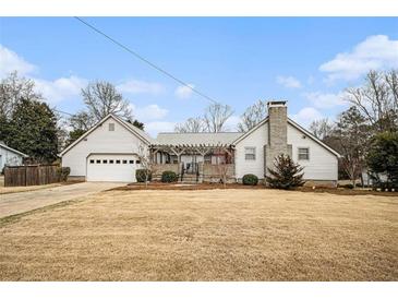 Charming single-story home with a two car garage and well-maintained lawn at 6325 S Summers S Cir, Douglasville, GA 30135