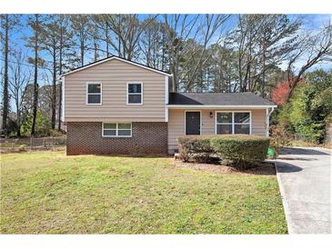 Charming split-level home featuring a well-maintained front yard and driveway at 1736 Inas Way, Tucker, GA 30084
