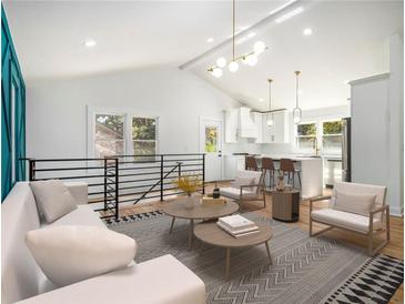 Bright open-concept living area with modern furniture, hardwood floors, and natural light streaming through the windows at 580 Hutchens Se Rd, Atlanta, GA 30354