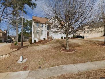 Charming two-story home featuring a manicured front yard and a classic architectural design at 144 Durham Lake Pkwy, Fairburn, GA 30213