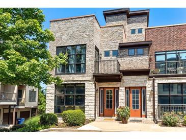 Stunning townhouse with a stone facade, large windows, and a welcoming entrance at 1199 Huff Rd # 121, Atlanta, GA 30318