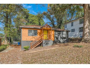 Charming exterior with natural wood and modern gray accents, surrounded by mature trees at 1251 Richland Sw Rd, Atlanta, GA 30310