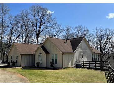 Charming single-story home featuring neutral siding, a well-maintained lawn, and mature trees at 8 Colonial Club Se Dr, Acworth, GA 30102