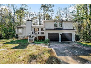 Charming two-story home with a two-car garage, chimney, and inviting front porch at 3485 Sheree Trl, Stone Mountain, GA 30087