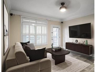 Bright living room with large window, sleek furniture, and neutral color palette at 955 Juniper Ne St # 4125, Atlanta, GA 30309