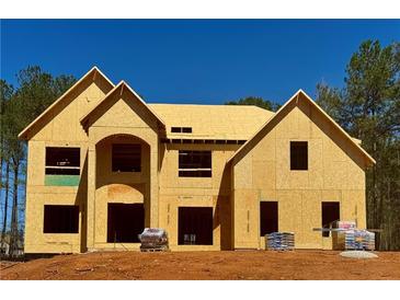 New construction home showing the facade and roof, framed with lumber and plywood at 254 Lotus Ln, Covington, GA 30016