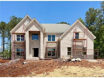 New two-story brick home featuring large windows and classic architectural details, currently under construction at 254 Lotus Ln, Covington, GA 30016