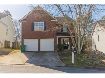 Charming two-story brick home with a two-car garage and well-maintained front yard at 3127 Leyland Ct, Decatur, GA 30034