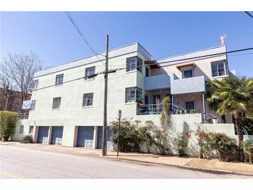 An exterior of a multi-Gathering building with colorful accents and multiple garage entrances at 589 Auburn Ne Ave # F, Atlanta, GA 30312